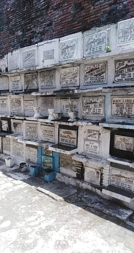 A closer look at "apartment tombs" in St Peter Catholic cemetery in Cavite City, Philippines.  Bodies are placed in the tombs initially for 2-3 years.