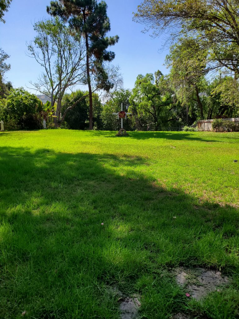 My photo showing the field that I think is the graveyard.  A large cross is displayed near the center of the field.
Taphophile visit to Mission San Diego de Alcala